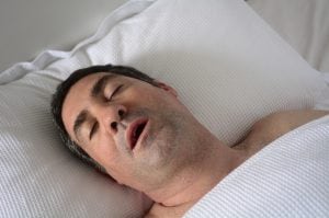 snoring man wonders about his risk level for sleep apnea