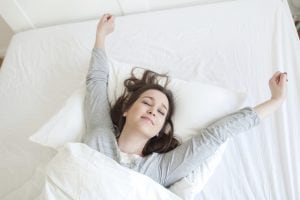 woman waking up feeling refreshed