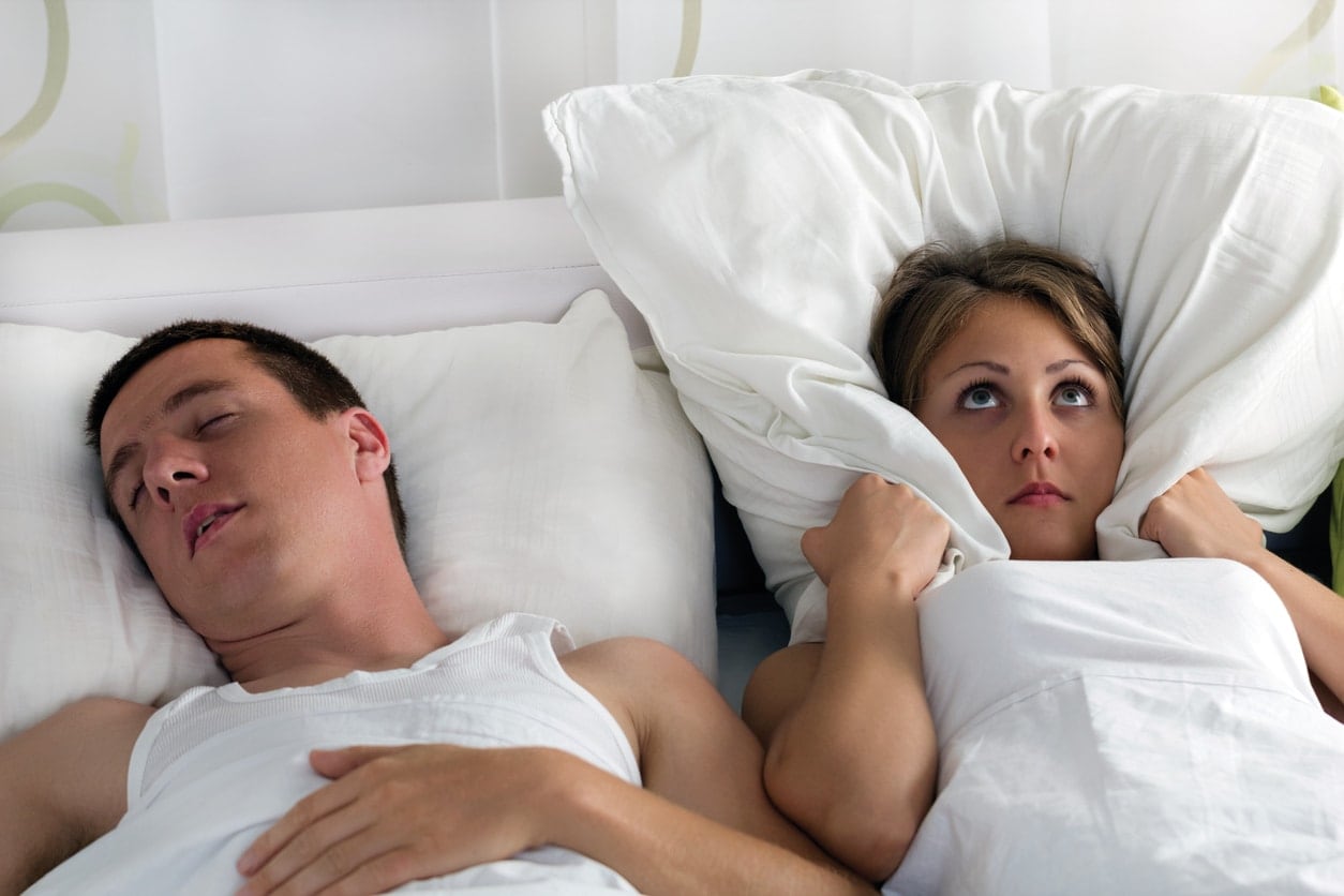 man keeping his wife awake with his snoring