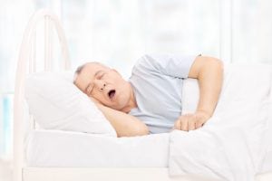 man snoring in bed