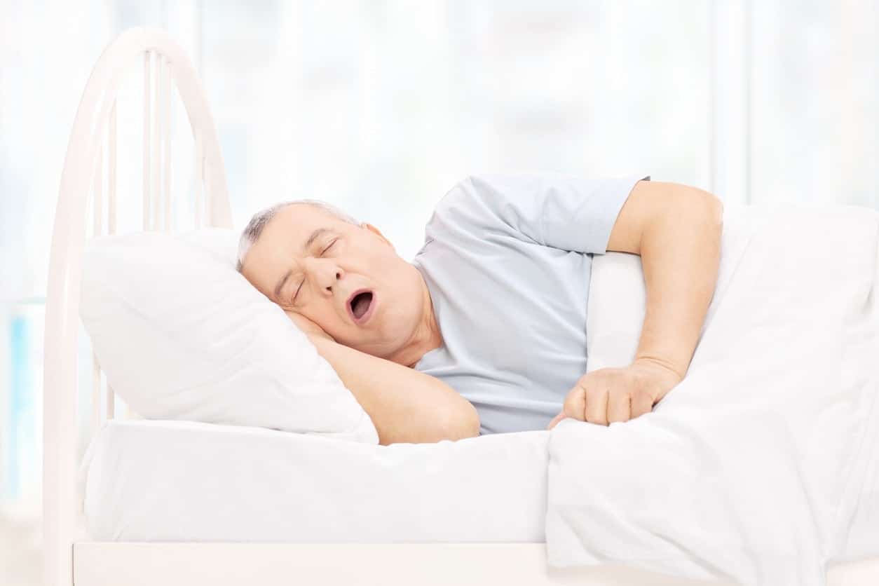 man snoring in bed