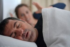 man suffering from sleep apnea