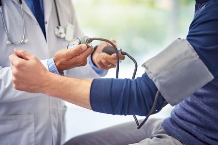 male getting blood pressure taken