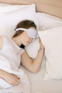 woman sleeping with a mask