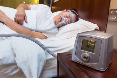 Asian man using CPAP in his sleep