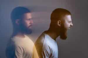 Side view double exposure of man showing calm and angry expressions, symbolizing mood changes from sleep apnea.