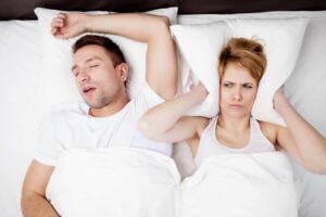 Wife annoyed by husband's snoring in bed - no one is getting good sleep.